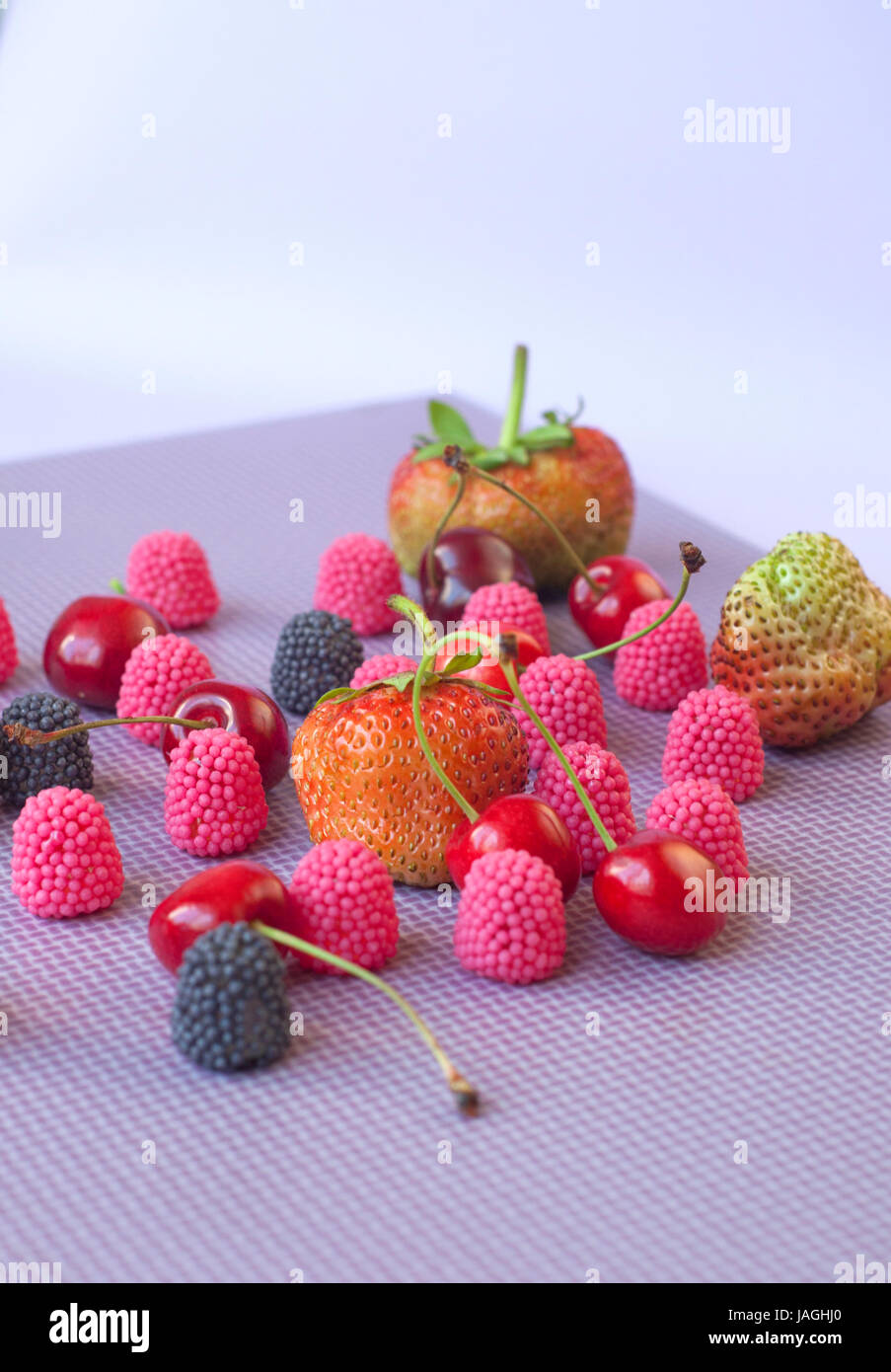 A group of strawberries, cherries and candies raspberry isolated on the ...