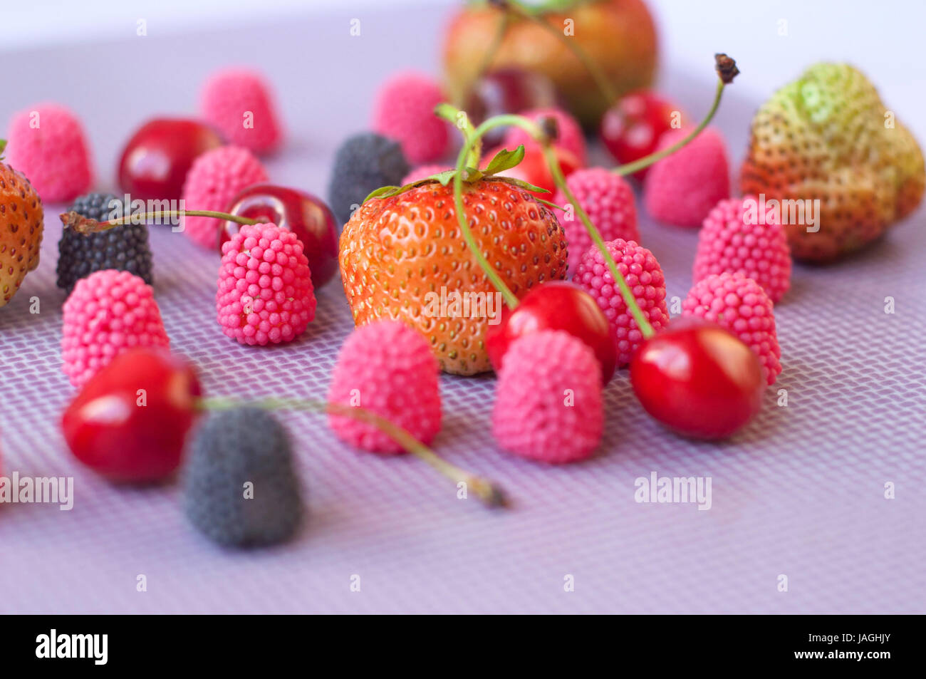 A group of strawberries, cherries and candies raspberry isolated on the ...