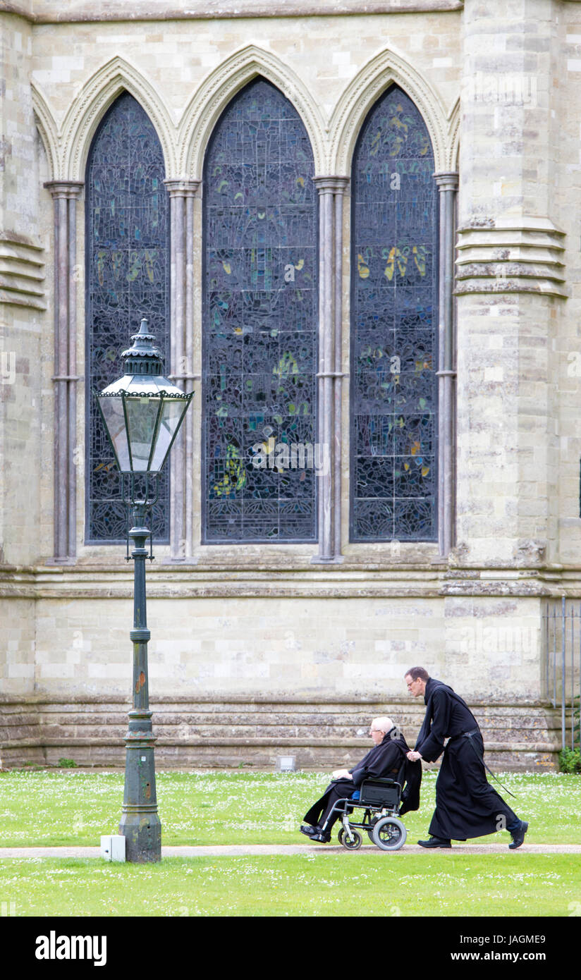 Clergymen outside Salisbury Cathedral, Salisbury, Wiltshire, England, UK Stock Photo