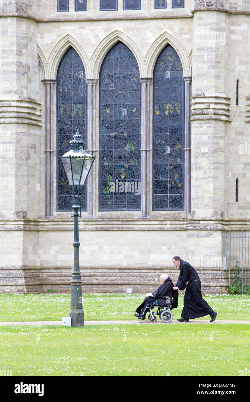 Clergymen outside Salisbury Cathedral, Salisbury, Wiltshire, England, UK Stock Photo