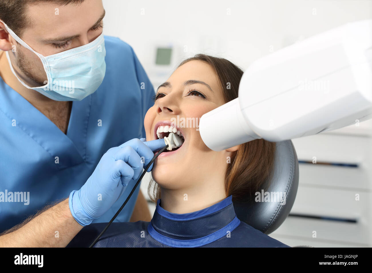 Dentist taking a teeth radiography to a patient in an office Stock Photo