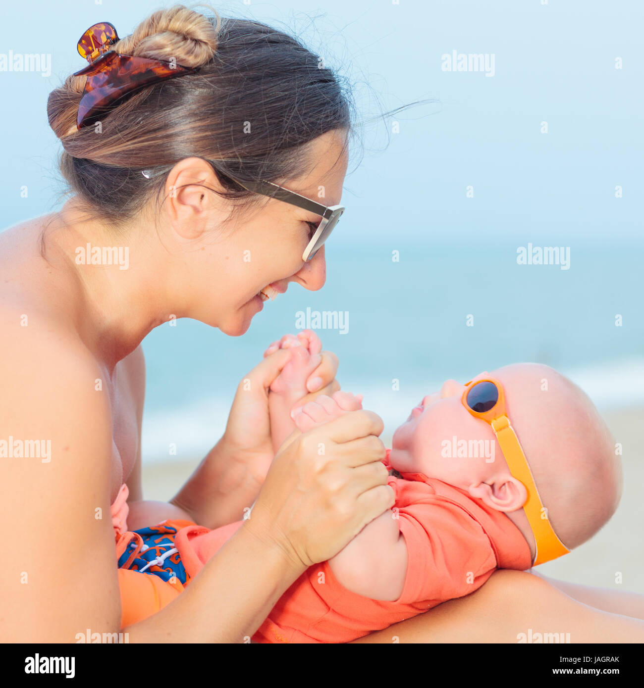 Baby and mom are relaxing on sunbed Stock Photo Alamy
