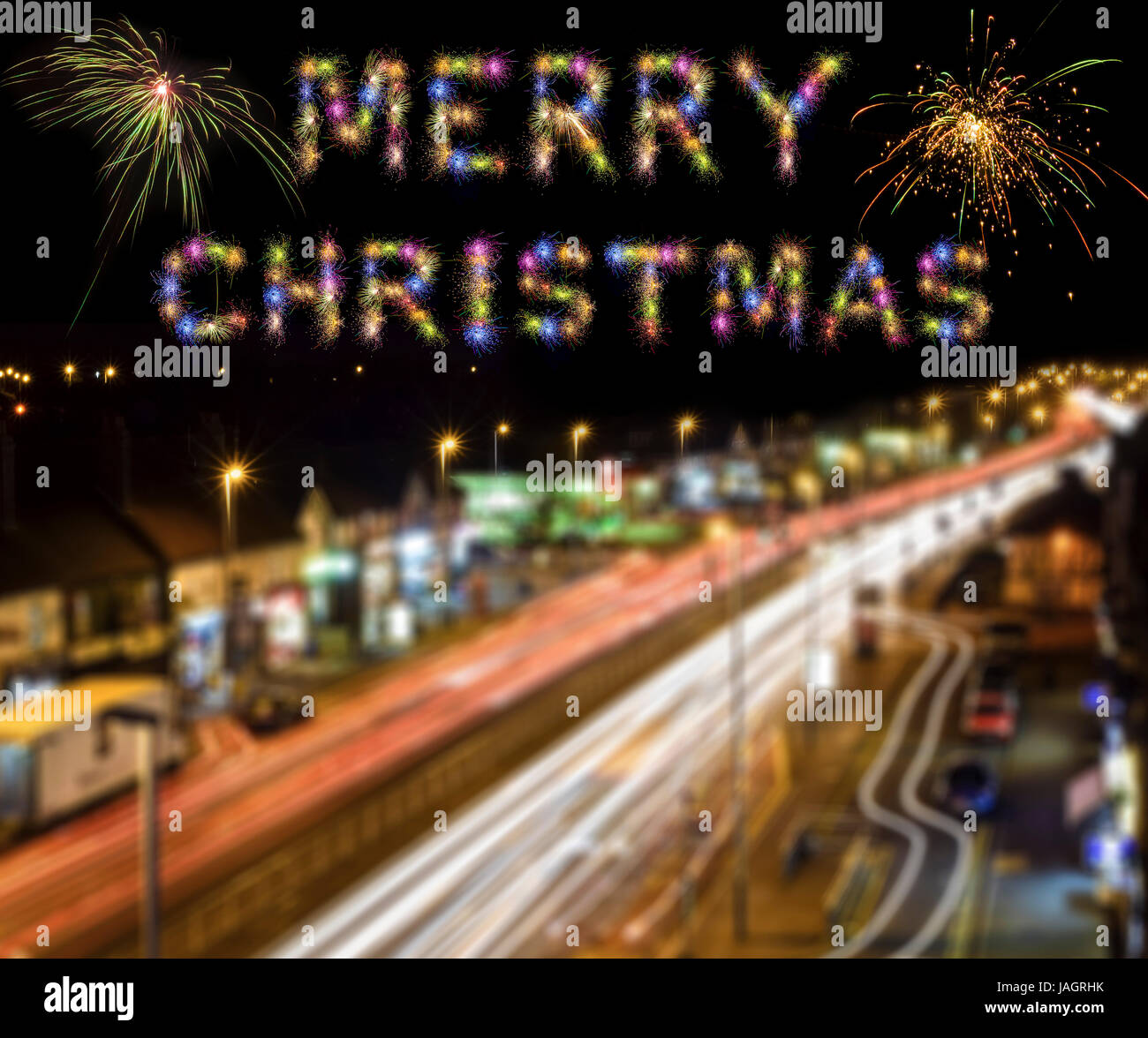 Merry Christmas written with Sparkle fireworks over London city light trails Stock Photo
