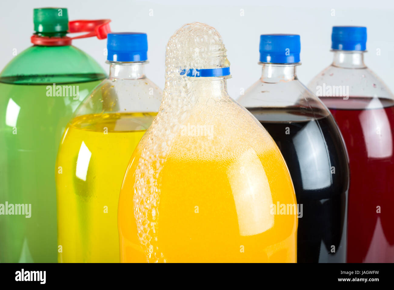 Carbonated drinks in plastic bottles. Multicolored drinks. Studio shot