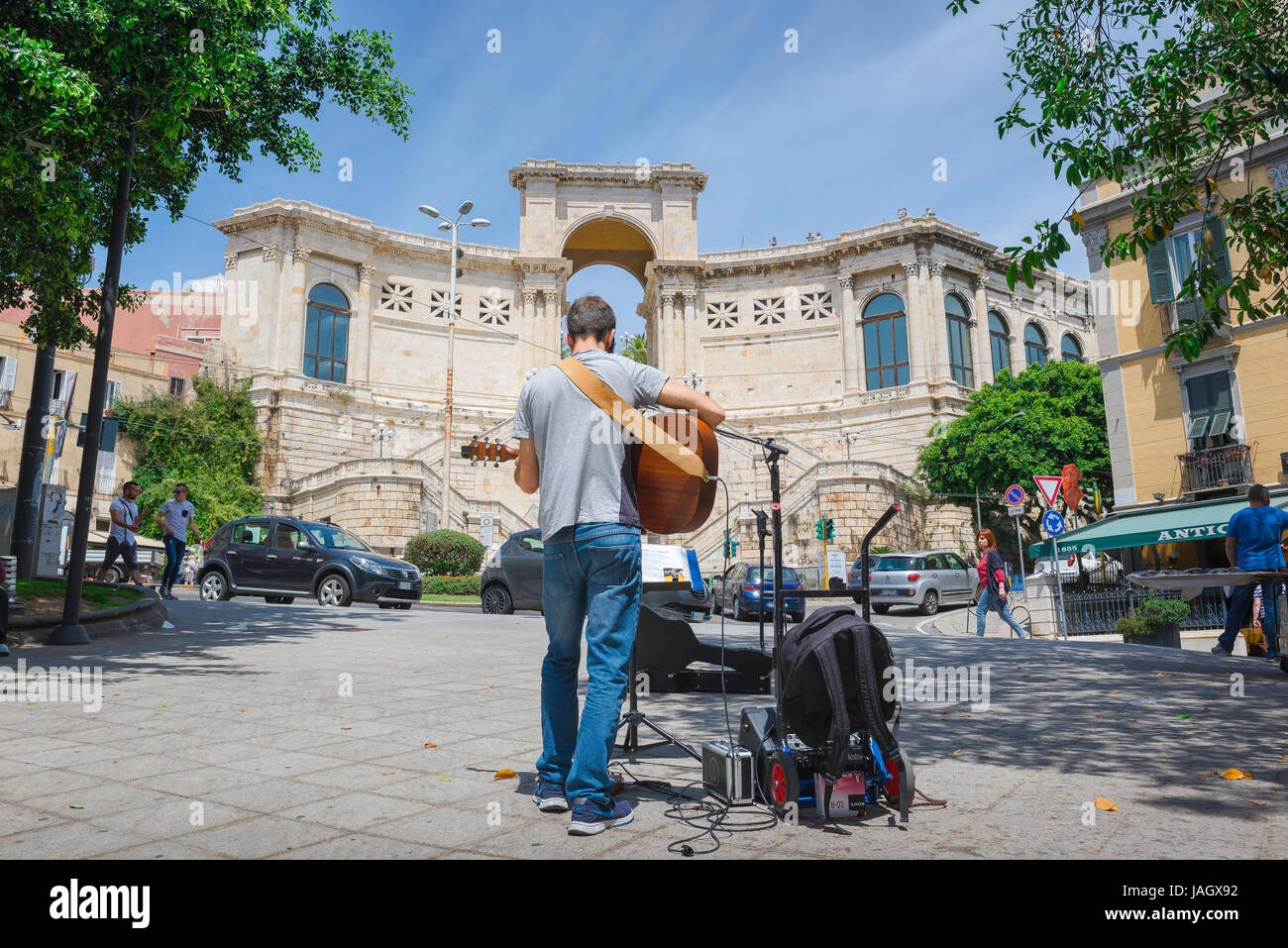 A busker plays his guitar in the Piazza Emanuele Ravot in the center of Cagliari, Sardinia. Stock Photo