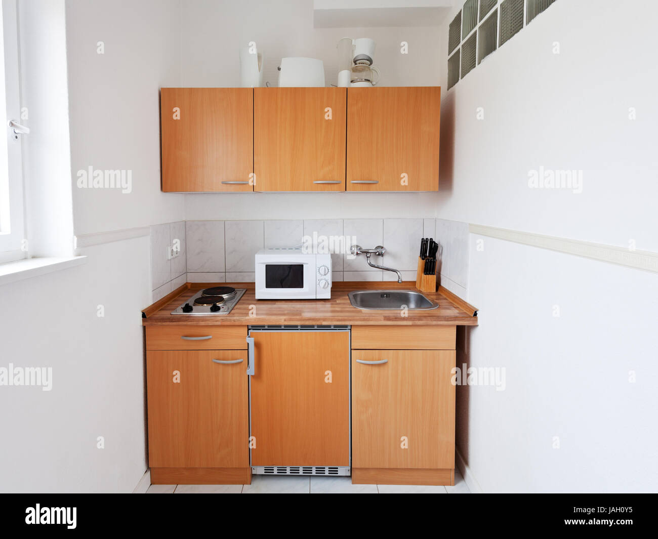 small kitchen with furniture set and kitchen equipment Stock Photo Alamy