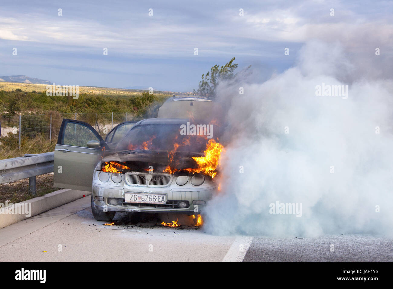 Croatia,burning car by the roadside, Stock Photo