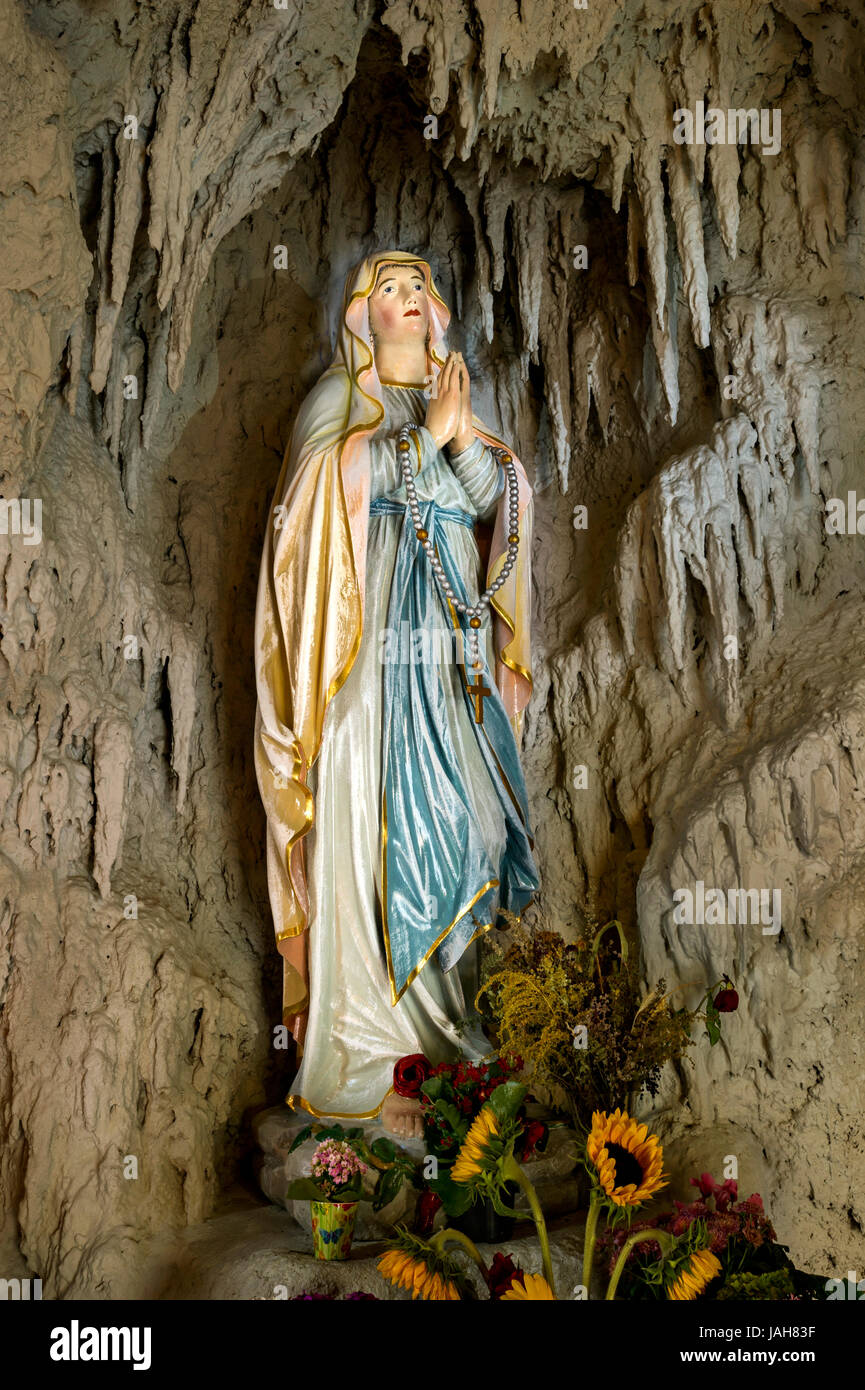 Lourdes grotto with a statue of the Virgin Mary, reconstruction of the grotto of Massabielle near Lourdes, parish church of St. Stock Photo