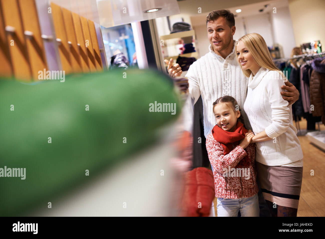 Portrait of modern young couple and their daughter spending time in the mall Stock Photo