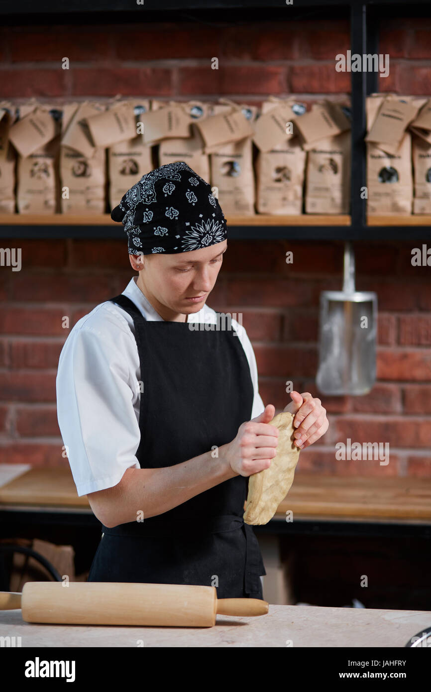 Woman kneading dough in kitchen Stock Photo - Alamy