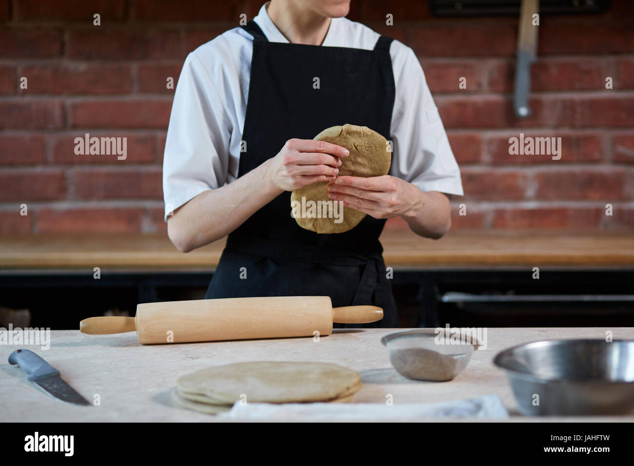 Woman kneading dough in kitchen Stock Photo - Alamy