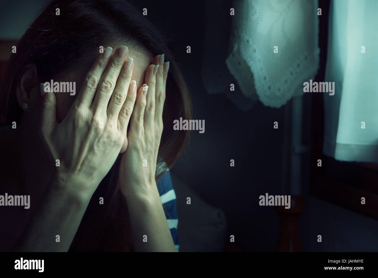 Woman covering her face with both hands, depression concept. Stock Photo