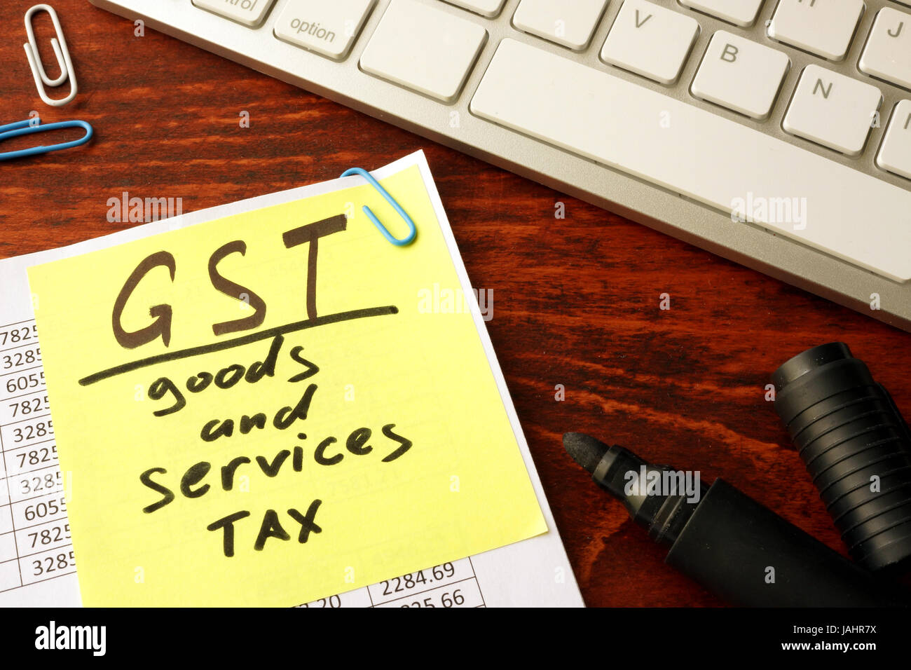 Notepad with word GST Goods and services tax. Stock Photo