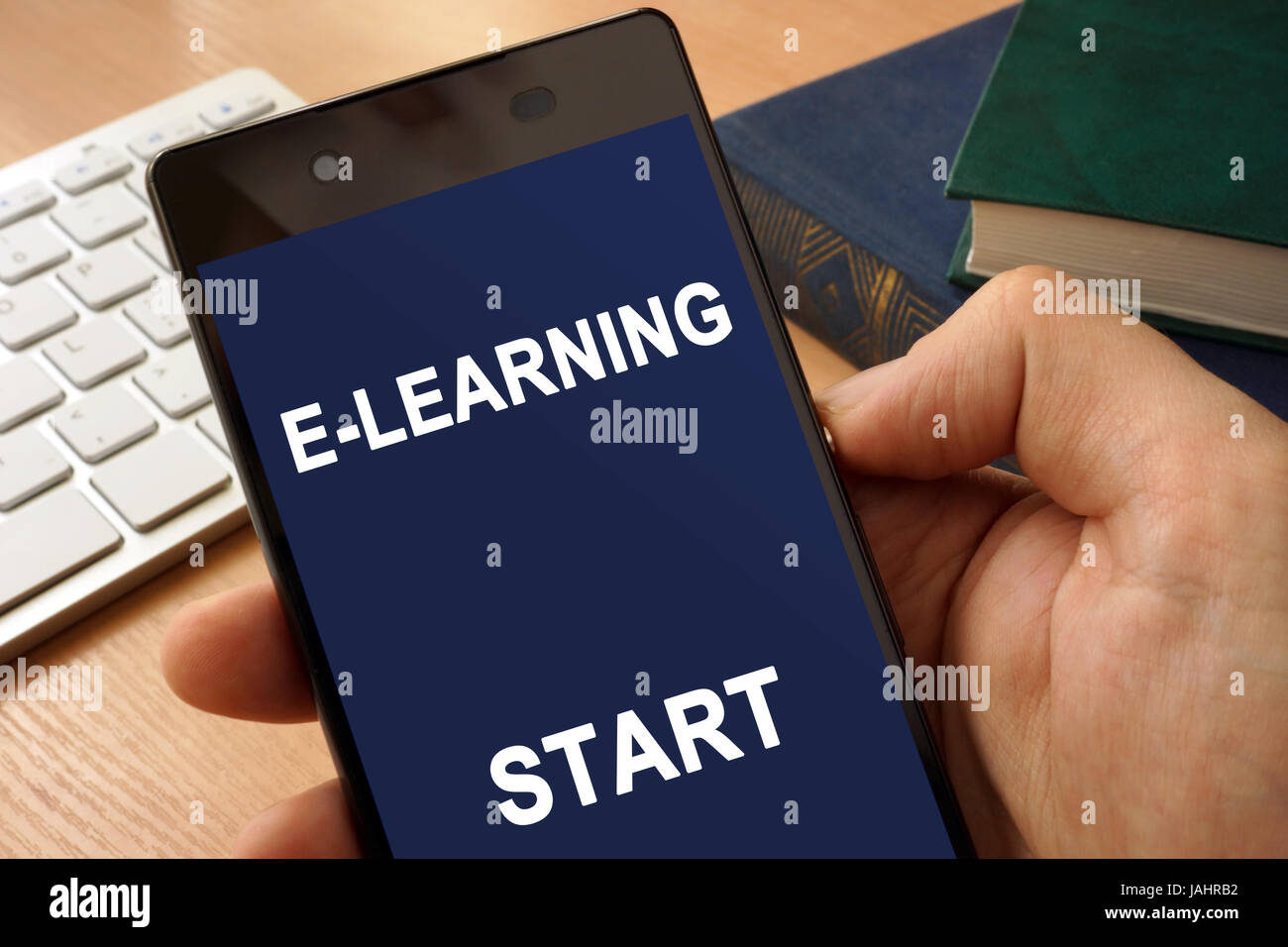 Hand with smartphone  and app E-learning. Distance education concept. Stock Photo