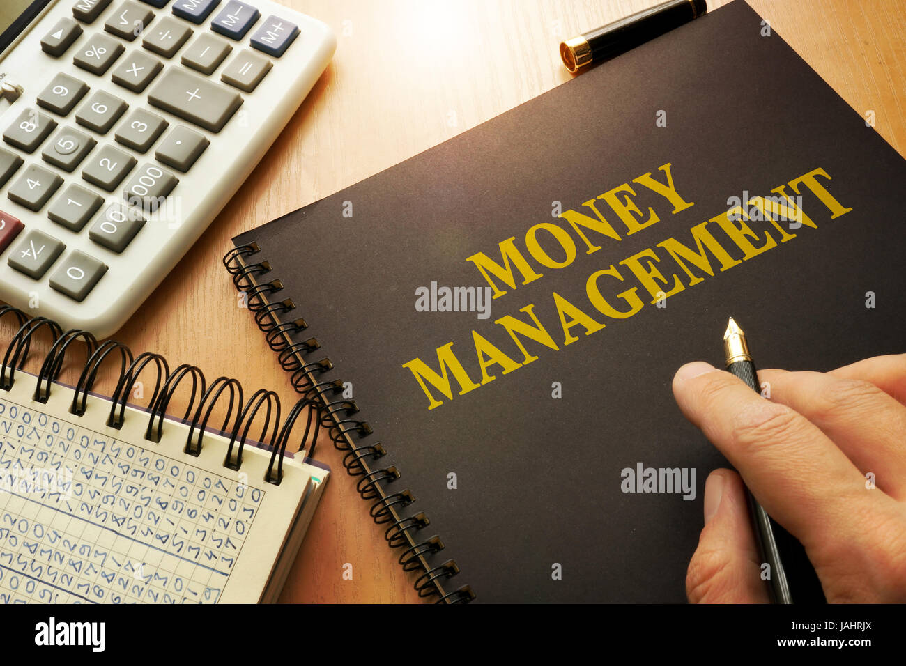 Book with money management on a table. Stock Photo