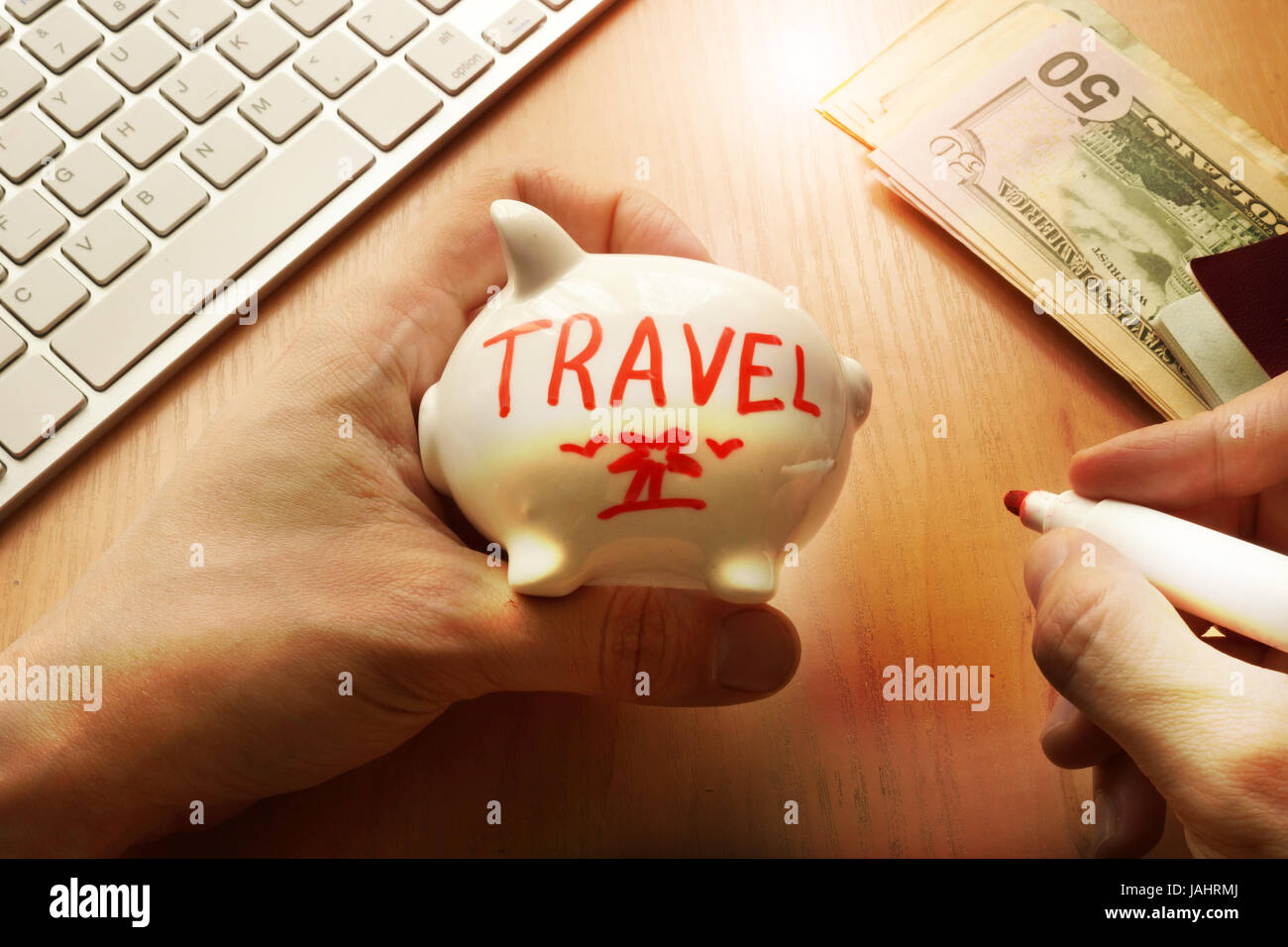 Hands are holding piggy bank with word travel. Savings concept. Stock Photo