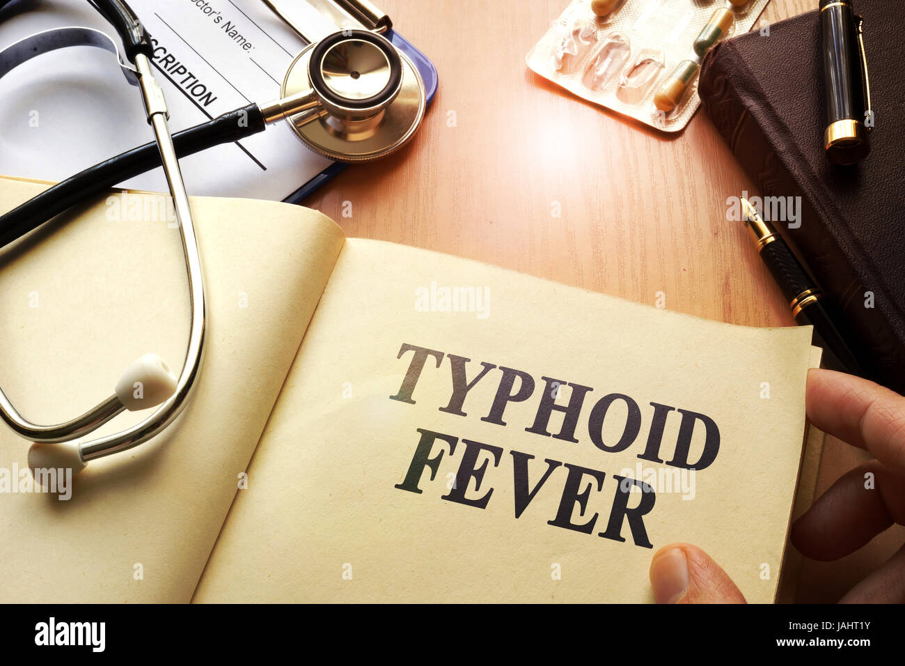 Book with title Typhoid Fever on a table. Stock Photo