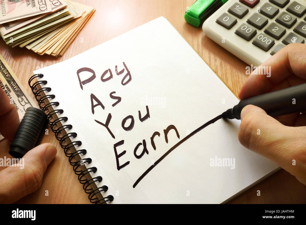 Pay As You Earn – PAYE written in a note. Stock Photo