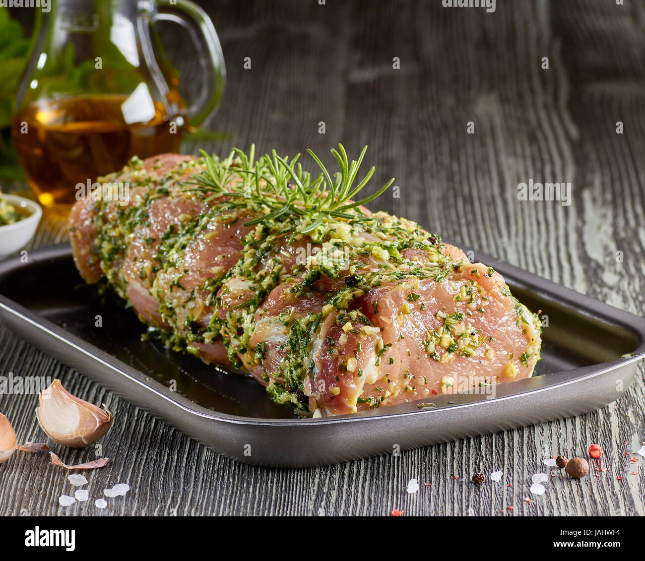 Raw pork loin with spices in baking tray. Stock Photo