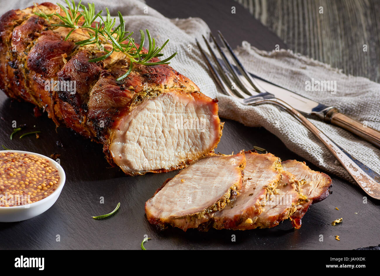 Baked pork loin with whole grain mustard Stock Photo Alamy