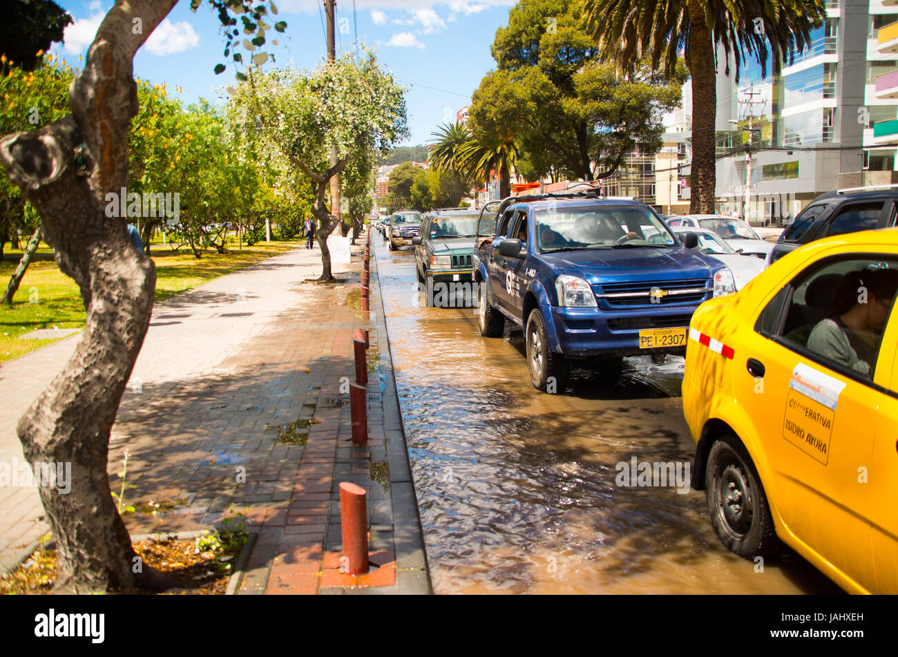 QUITO, ECUADOR SEPTEMBER 20, 2016 Car rides on a flooded road in