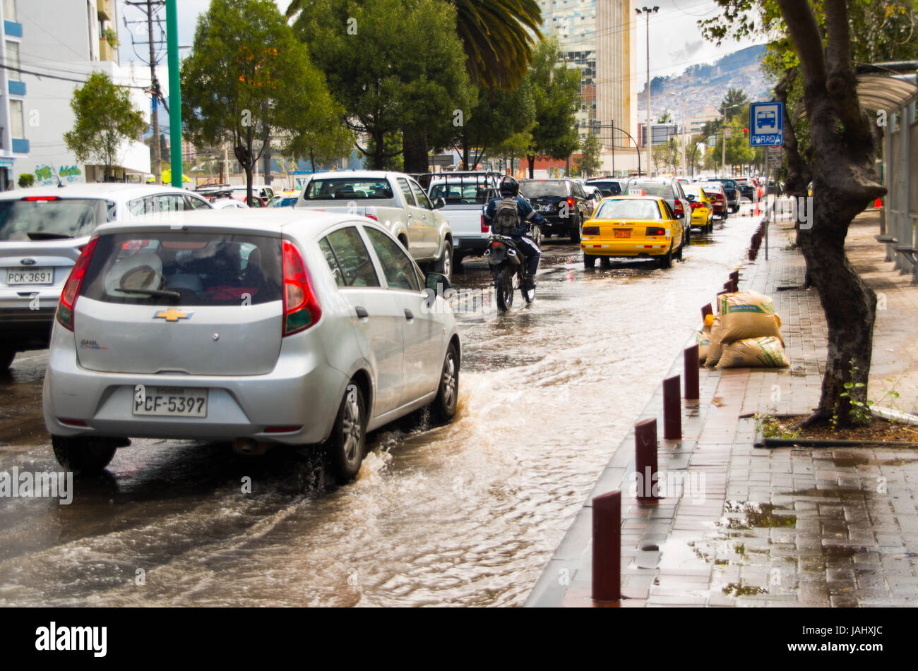 QUITO, ECUADOR SEPTEMBER 20, 2016 A motocycle and car rides on a