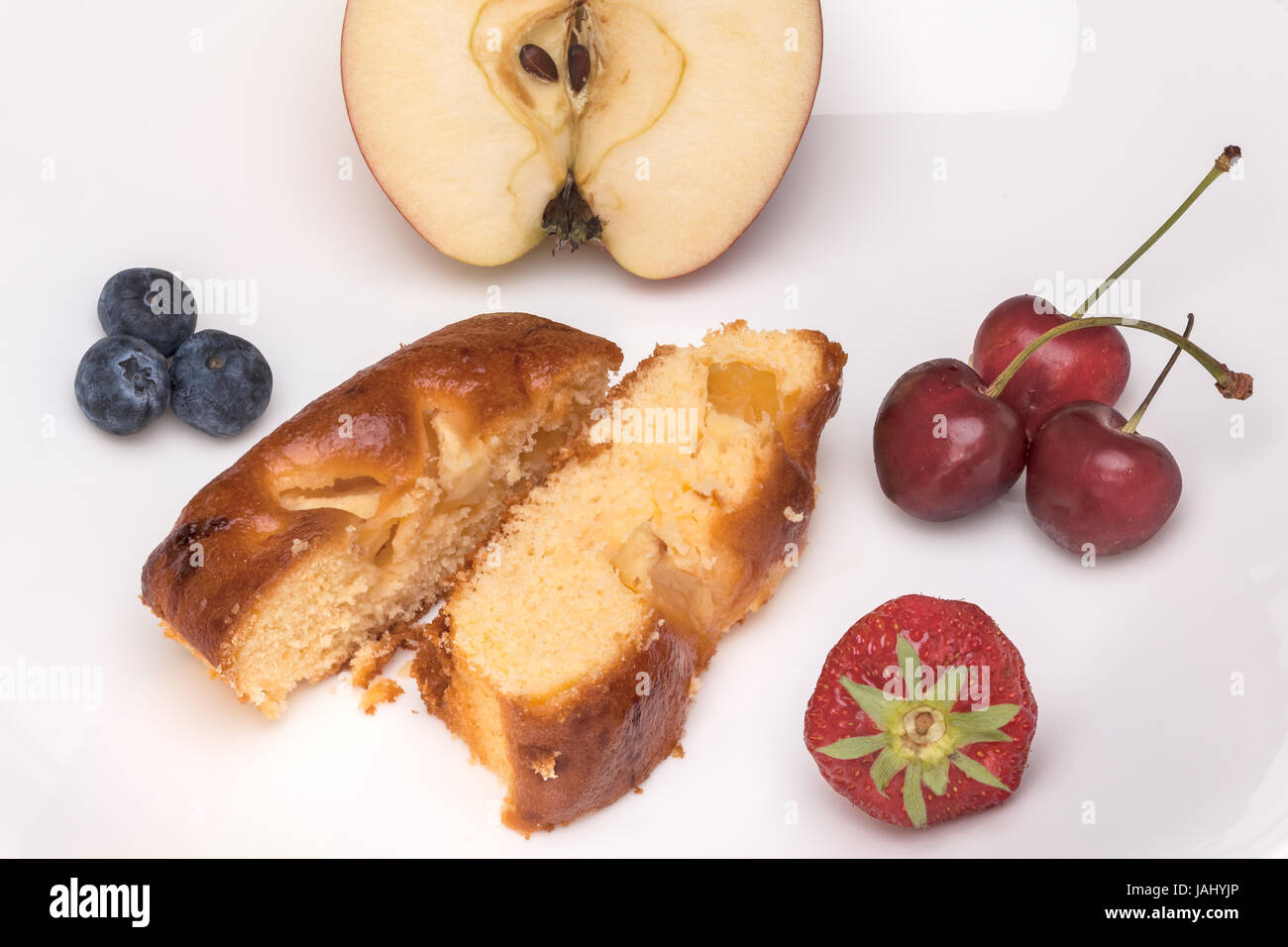 An elongated apple cake with coffee and fruit Stock Photo