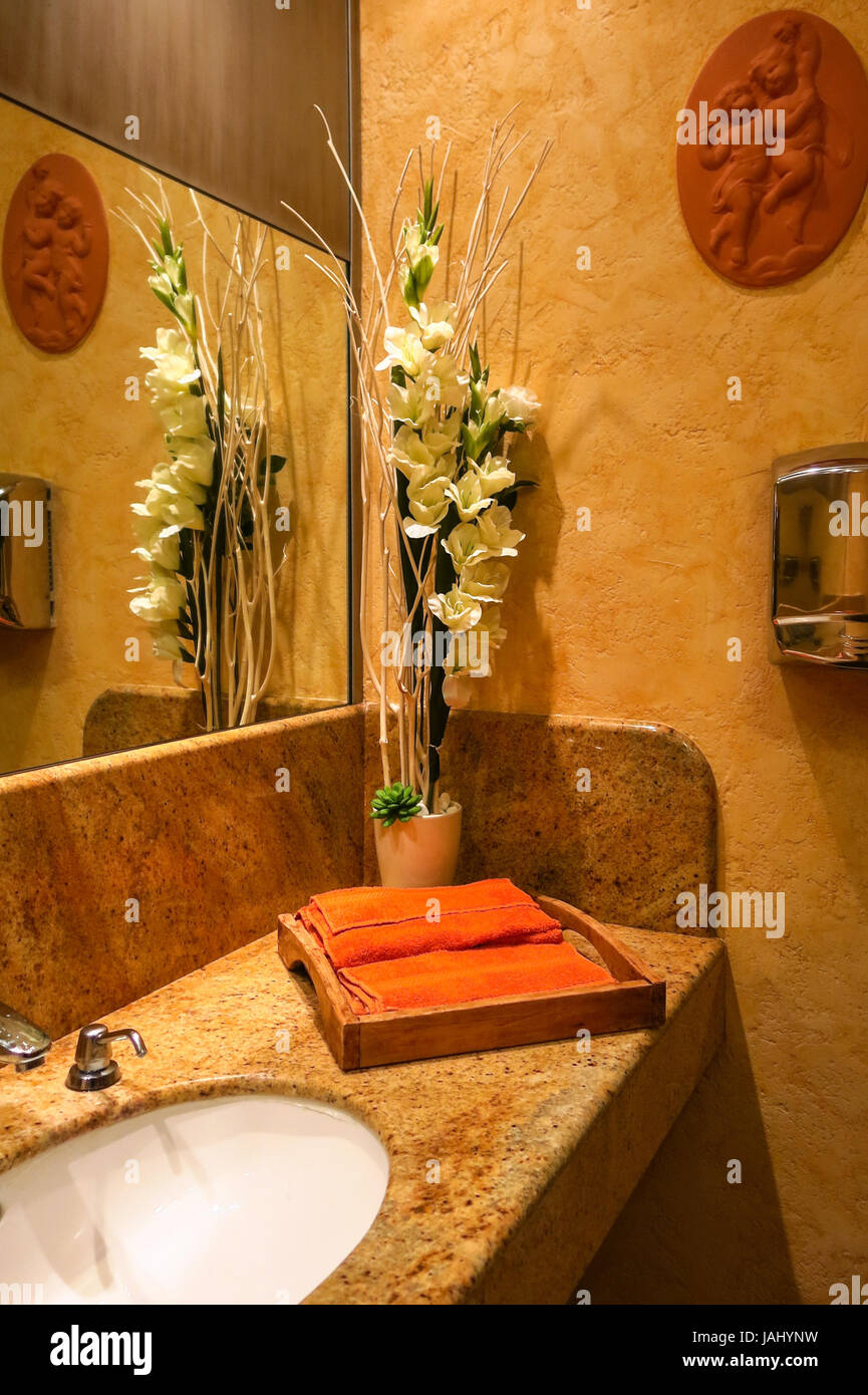 Washbasin with towel and decoration in bathroom Stock Photo - Alamy
