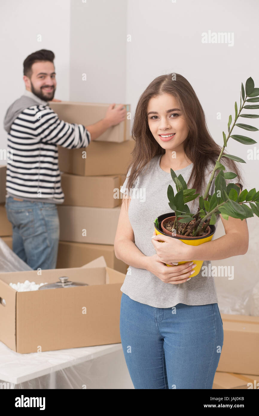 Happy young couple unpacking boxes and moving into a new home Stock ...