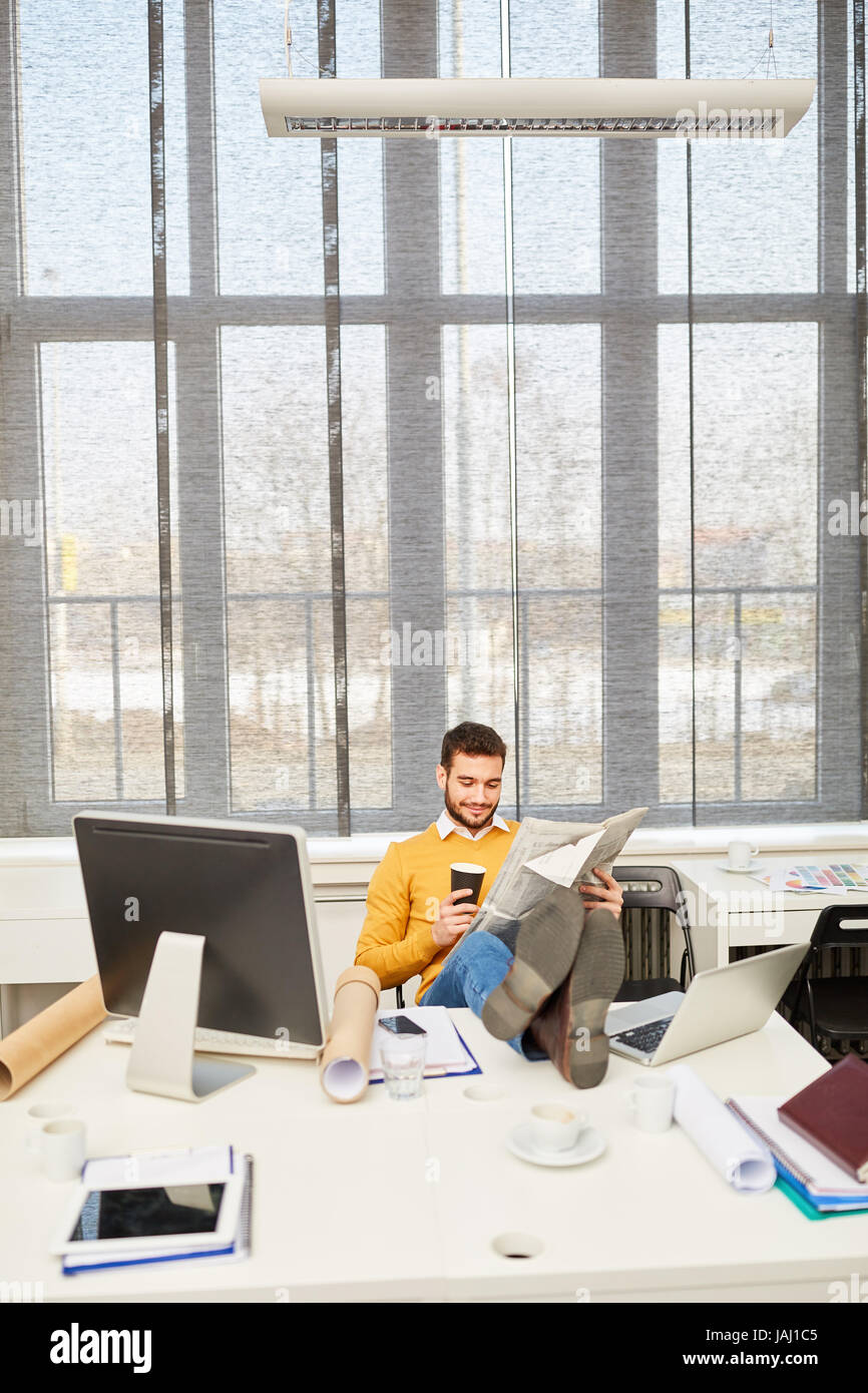 Businessman with feet on table at his place of work Stock Photo