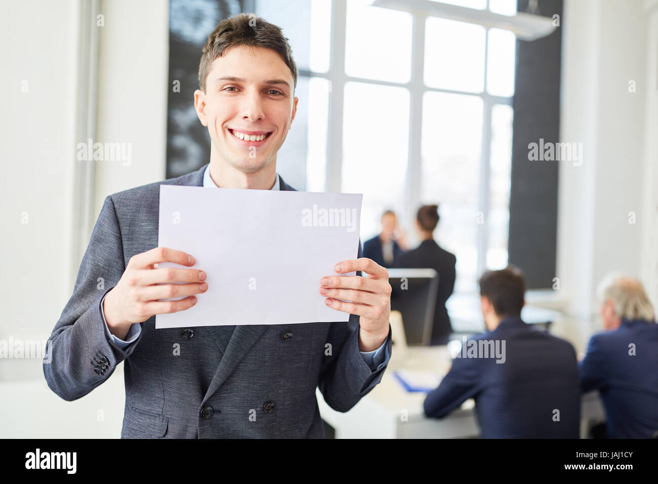 Young businessman holiding empty sign in his office Stock Photo - Alamy