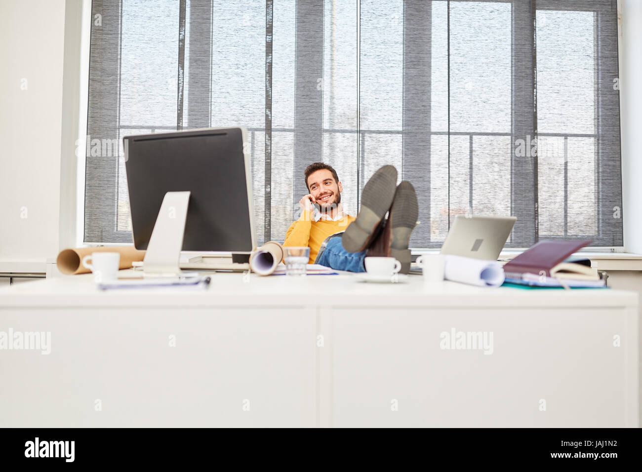 Young man in a break at place of work looking relaxed Stock Photo