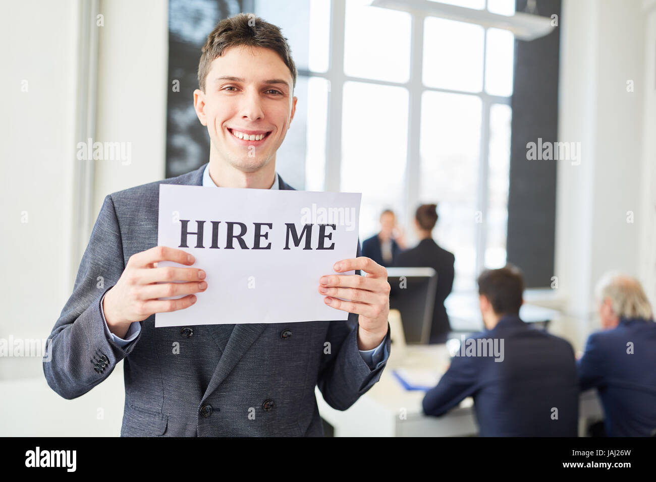 Job candidate holds sign for finding a job Stock Photo