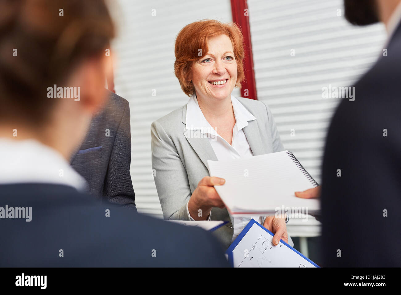 Personnel manager accepts application from candidate in assessment center Stock Photo