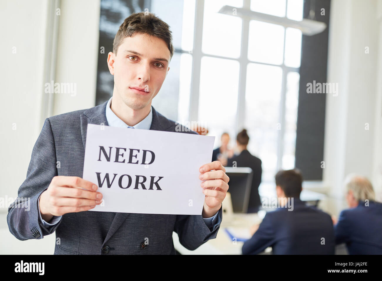 Unemployed man wants to find a job and holds sign Stock Photo