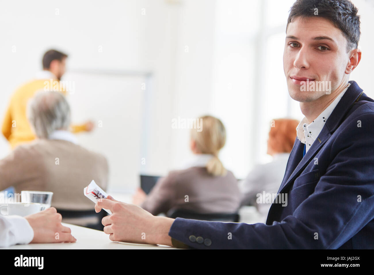 Young man as businessman or student or business trainee Stock Photo