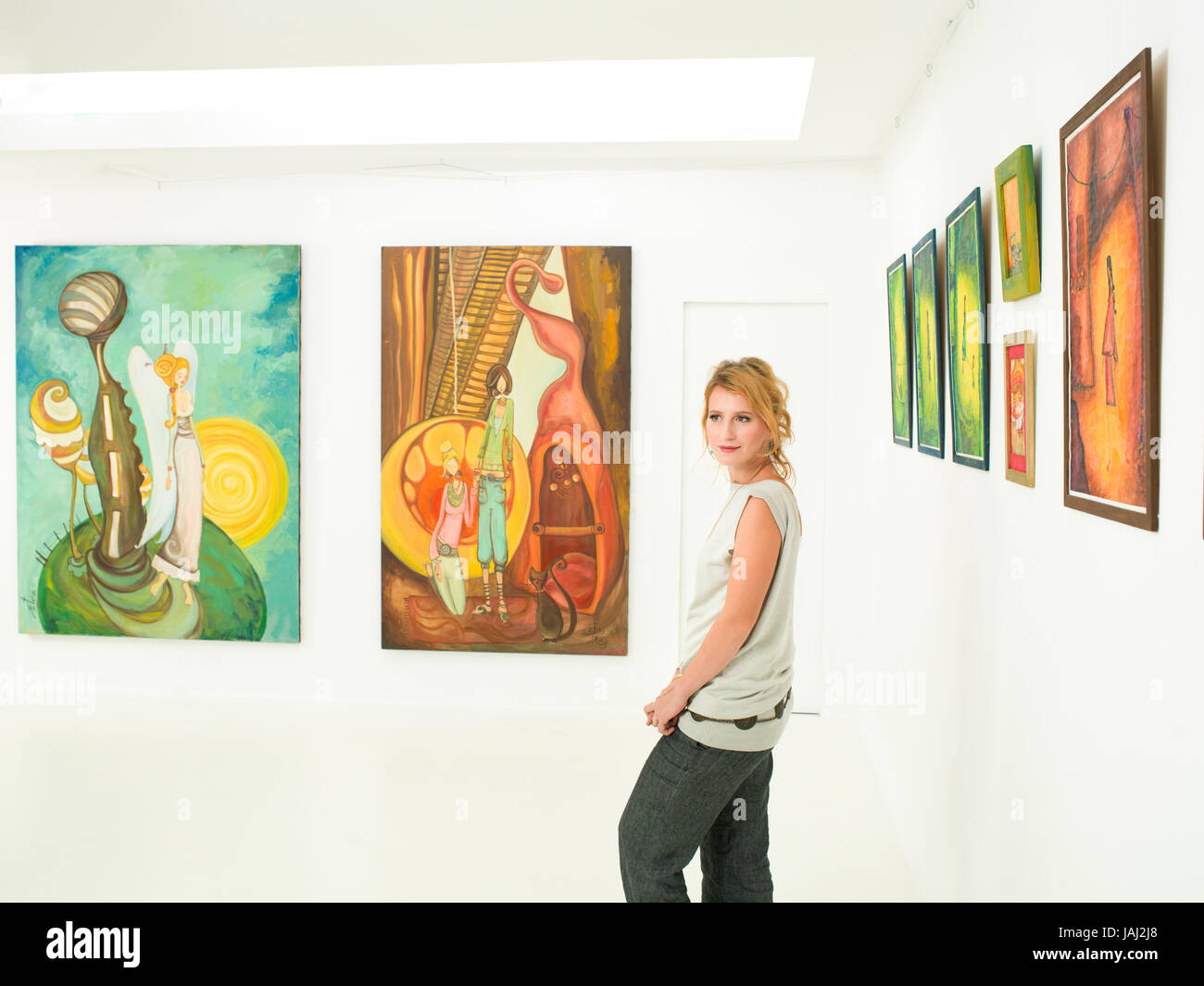 young caucasian woman standing and posing in an art gallery Stock Photo ...