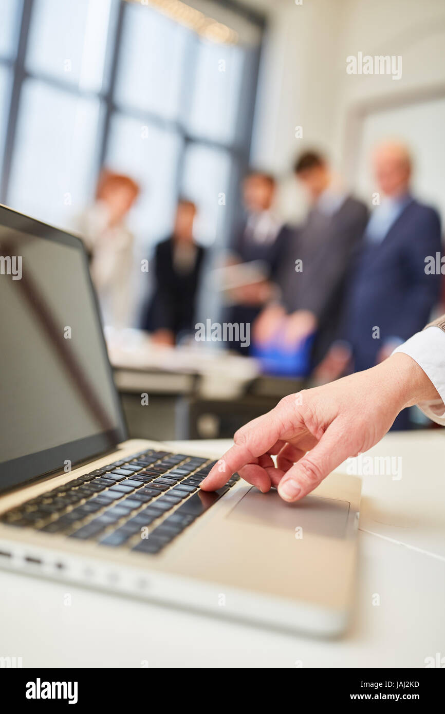 Business man types on laptop computer as digital communication concept Stock Photo