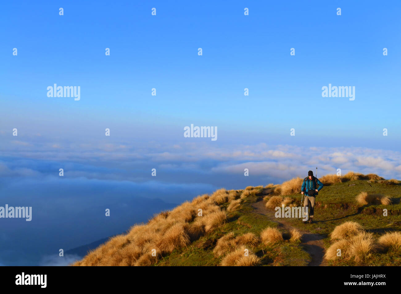 Single Traveler (man) above the clouds. Mountain Landscape in Himalaya. Nepal Stock Photo