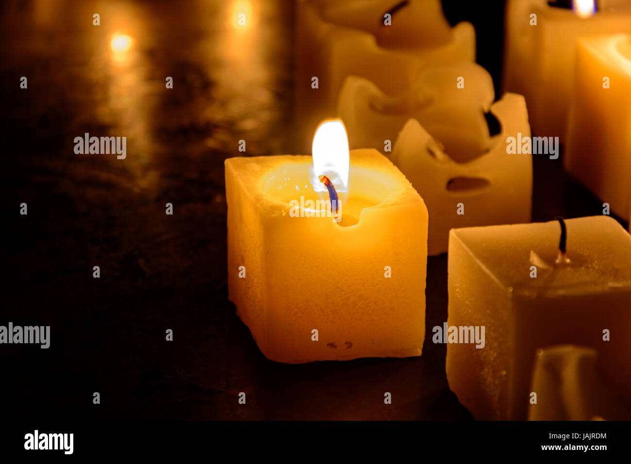 Candles lit and melted with dark background Stock Photo Alamy