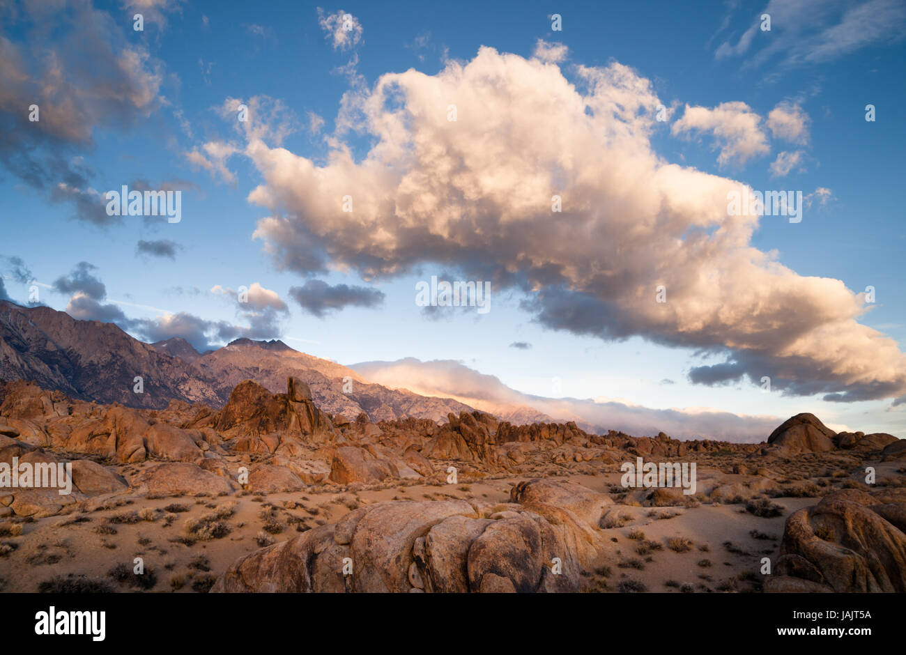 A big beautiful white cloud mass passes over the Alabama Hills in California Stock Photo