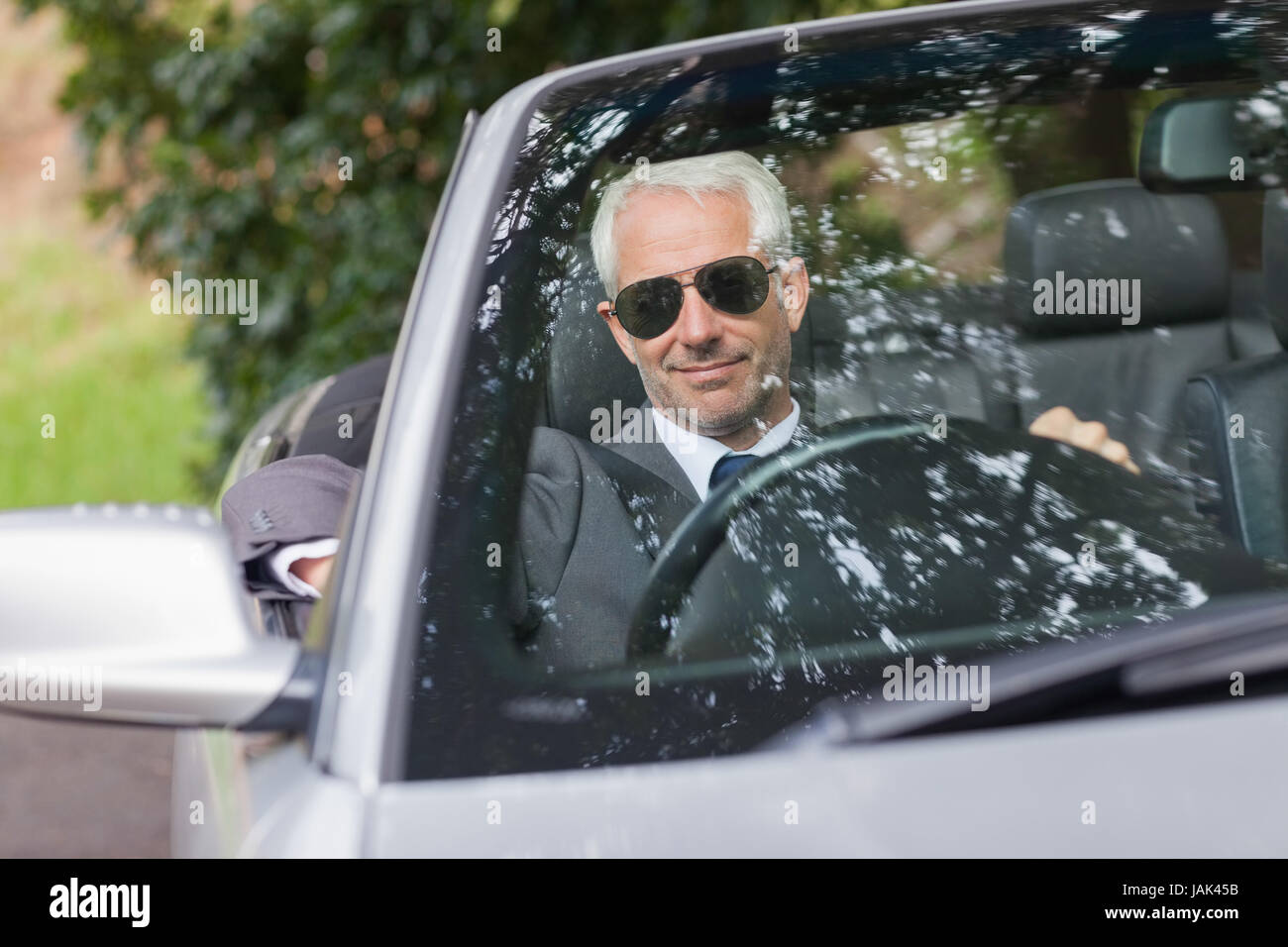 Cheerful mature businessman driving classy cabriolet on sunny day Stock ...