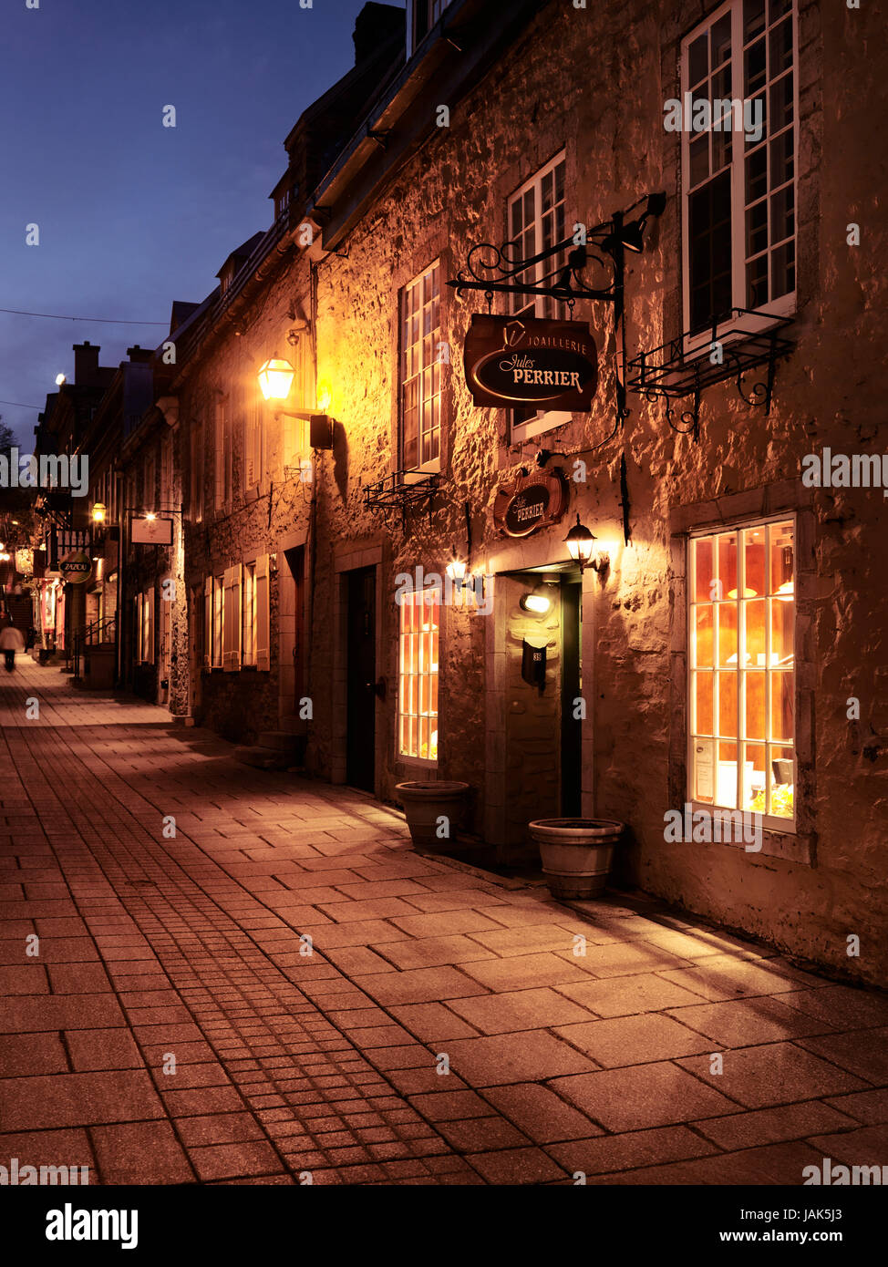 License and prints at MaximImages.com - shops lit with street light at night in Old Quebec City Petit Champlain historic street, Quebec, Canada. Stock Photo