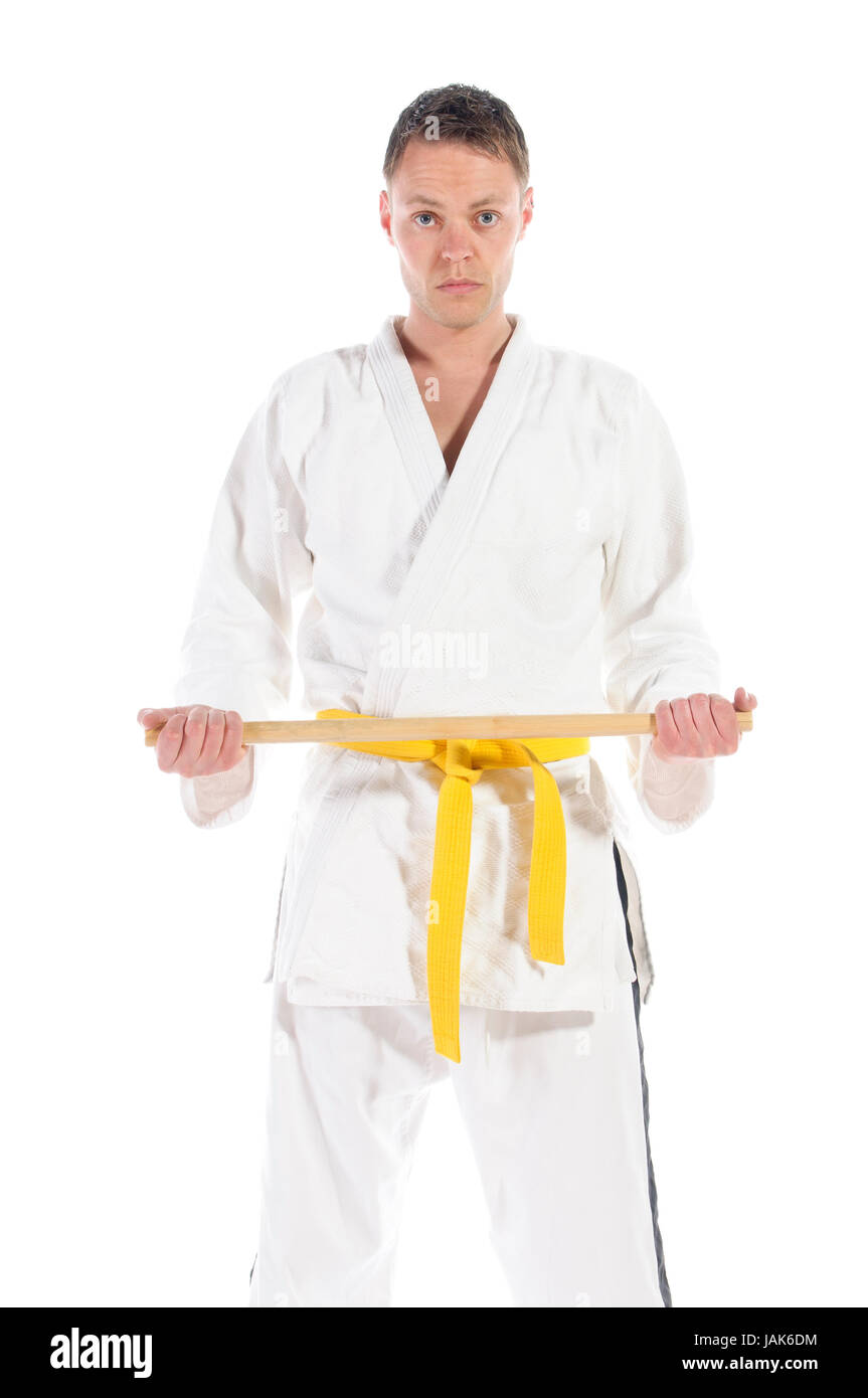 Mann macht Jiu Jitsu Kampfsport Übungen in typischem weißer Anzug, freigestellt vor weißem Hintergrund. Stock Photo