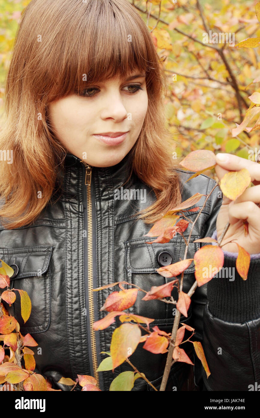 Portrait of a beautiful young woman in autumn park Stock Photo - Alamy