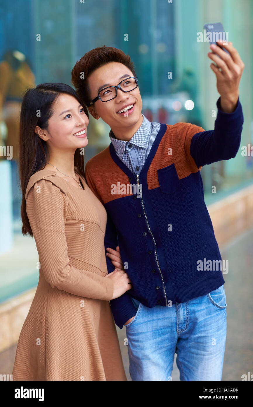 Young Chinese couple Shopping in the Street Stock Photo