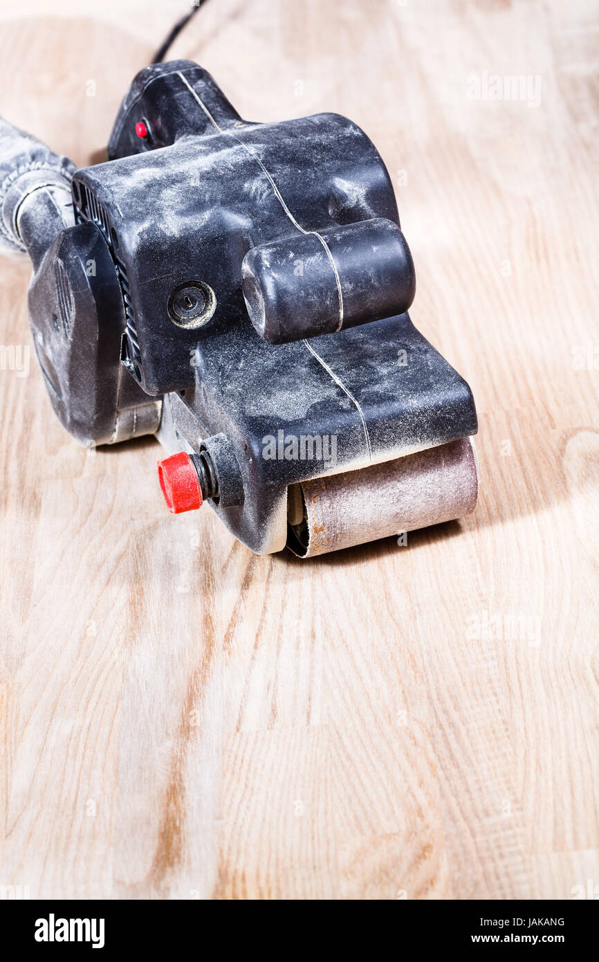 finishing ashwood furniture board by handheld belt sander Stock Photo Alamy