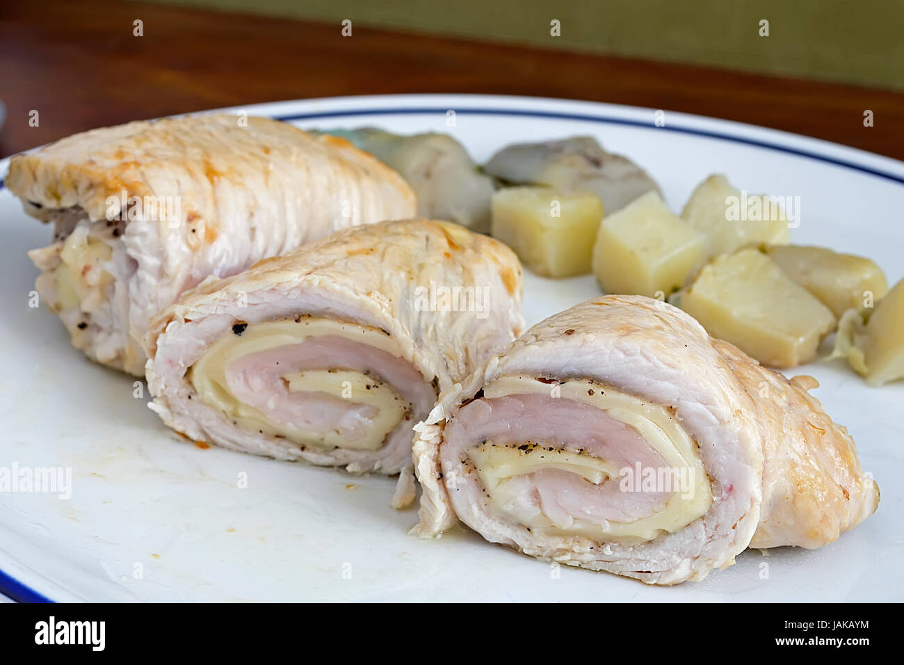 turkey rolls with cheese on a white plate Stock Photo - Alamy