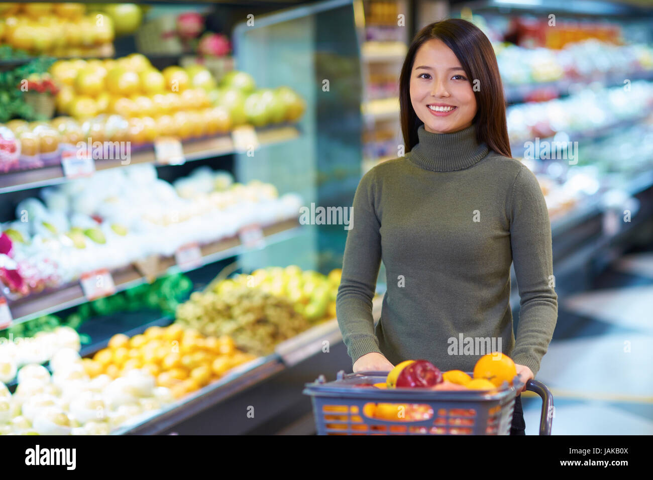 One Young Chinese Woman Shopping in the Supermarket Stock Photo
