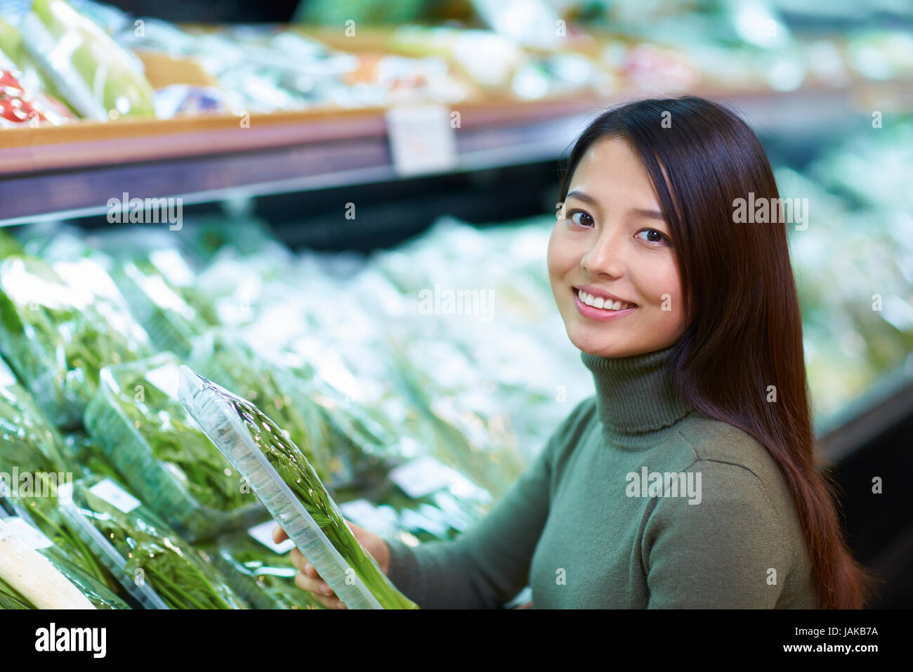 One Young Chinese Woman Shopping in the Supermarket Stock Photo